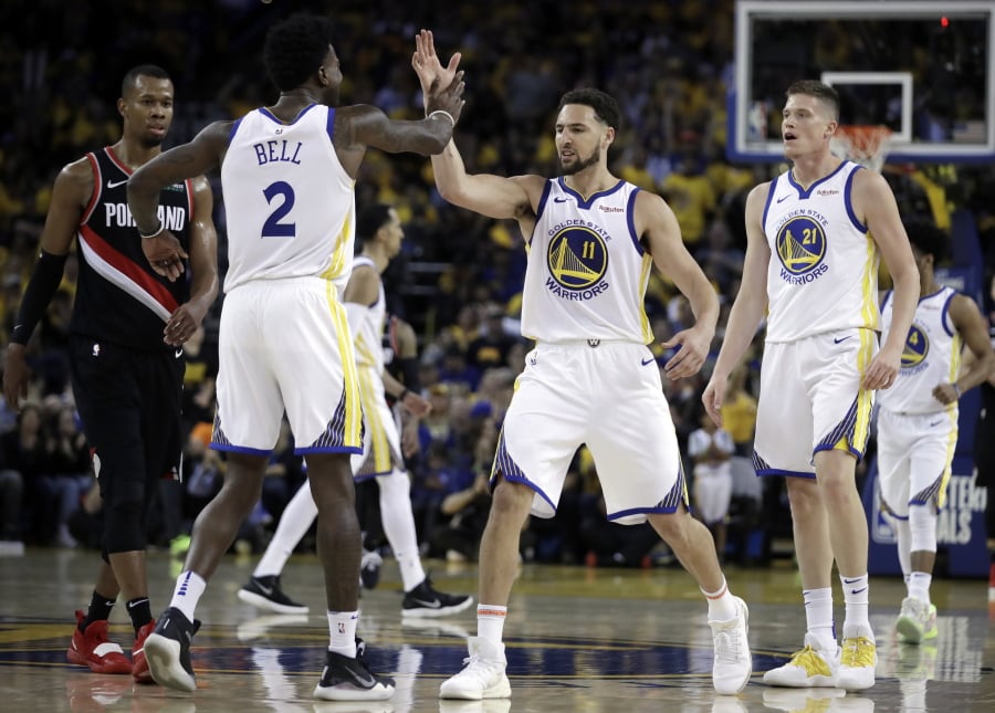 Golden State Warriors’ Klay Thompson (11) celebrates a score with Jordan Bell (2) during the second half of Game 1 of the team’s NBA basketball playoffs Western Conference finals against the Portland Trail Blazers on Tuesday, May 14, 2019, in Oakland, Calif.