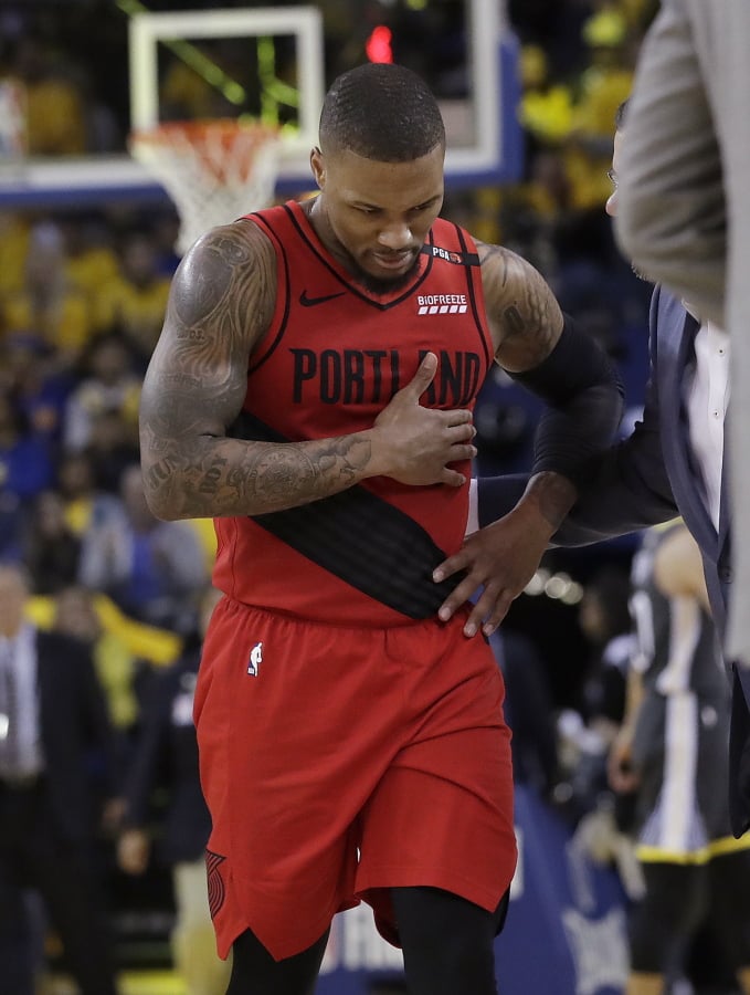 Portland Trail Blazers guard Damian Lillard walks to the bench during the second half of Game 2 of the team’s NBA basketball playoffs Western Conference finals against the Golden State Warriors in Oakland, Calif., Thursday, May 16, 2019.