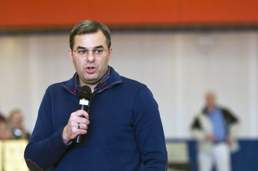 FILE - In this Thursday, Feb. 23, 2017 file photo, U.S Rep. Justin Amash, R-Cascade Township, speaks to the audience during a town hall meeting at the Full Blast Recreation Center in Battle Creek, Mich. Amash, a Republican congressman from Michigan says he’s concluded that President Donald Trump has “engaged in impeachable conduct.” Congressman Justin Amash tweeted Saturday, May 18, 2019 that he has read the entire redacted version of special counsel Robert Mueller’s Russia report.