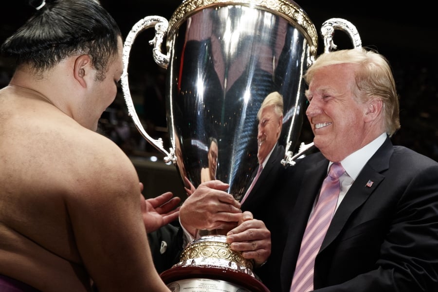 President Donald Trump presents the “President’s Cup” to Tokyo Grand Sumo Tournament winner Asanoyama, at Ryogoku Kokugikan Stadium, Sunday, May 26, 2019, in Tokyo.