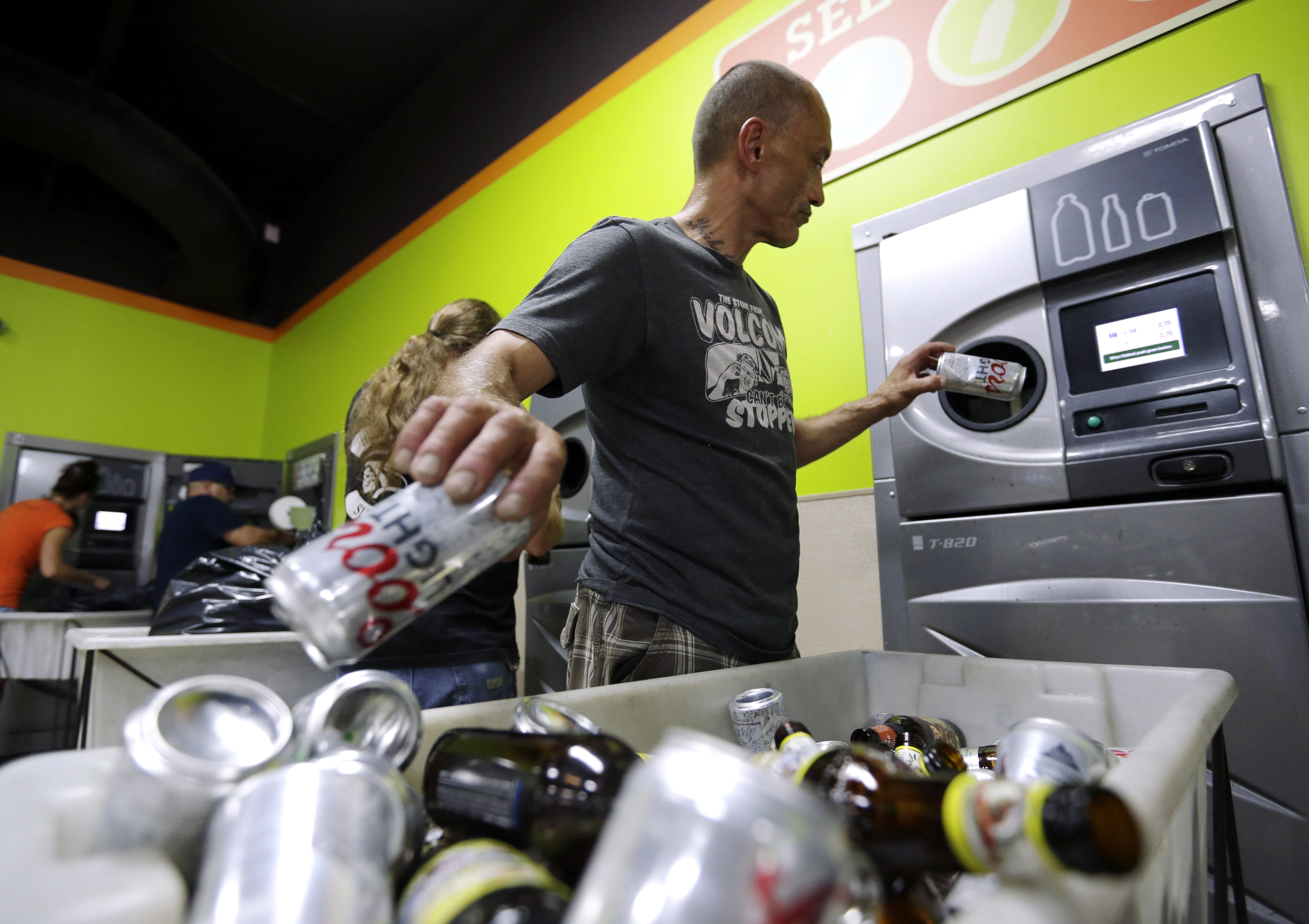 Michael Swadberg turns in bottles at a Bottledrop Oregon Redemption Center on July 31, 2015, in Gresham, Ore. Over the last year, reports of people rummaging through recycling bins have increased in Clark County. The target of these scavengers has been discarded bottles and cans, which have become increasingly valuable on the other side of the Columbia River. While local governments in Clark County have limited tools and their efforts are just starting, they could soon get help from Oregon. Last week, the Oregon Legislature passed a bill that's intended to deter people seeking to cash in on out-of-state containers.