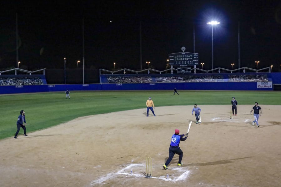 After daylong fasting and late-night prayers Taraweeh of Ramadan, these South Asian men enjoy playing cricket at Big League Dreams stadium in West Covina, keeping the tradition of Ramadan.