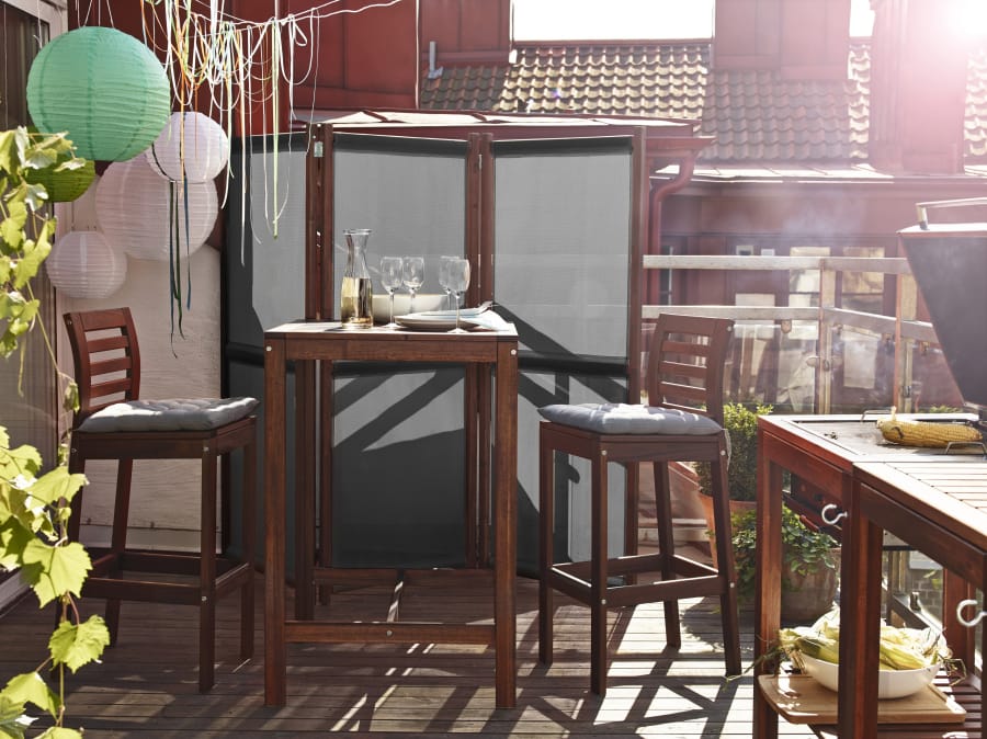 A bar table and stools add a little height to the balcony without taking up too much space.