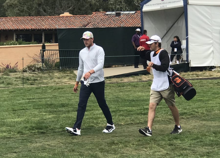 Spencer Tibbits, left, and caddie Keith Lobis walk off the tee during the first round of the U.S. Open at Pebble Beach, Calif., on Thursday.