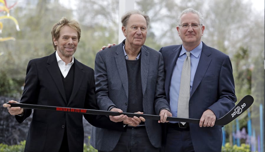 Part-owners, from left to right, Jerry Bruckheimer and David Bonderman pose with Tod Leiweke when Leiweke was named as the president and CEO of the Seattle NHL team in April 2018.