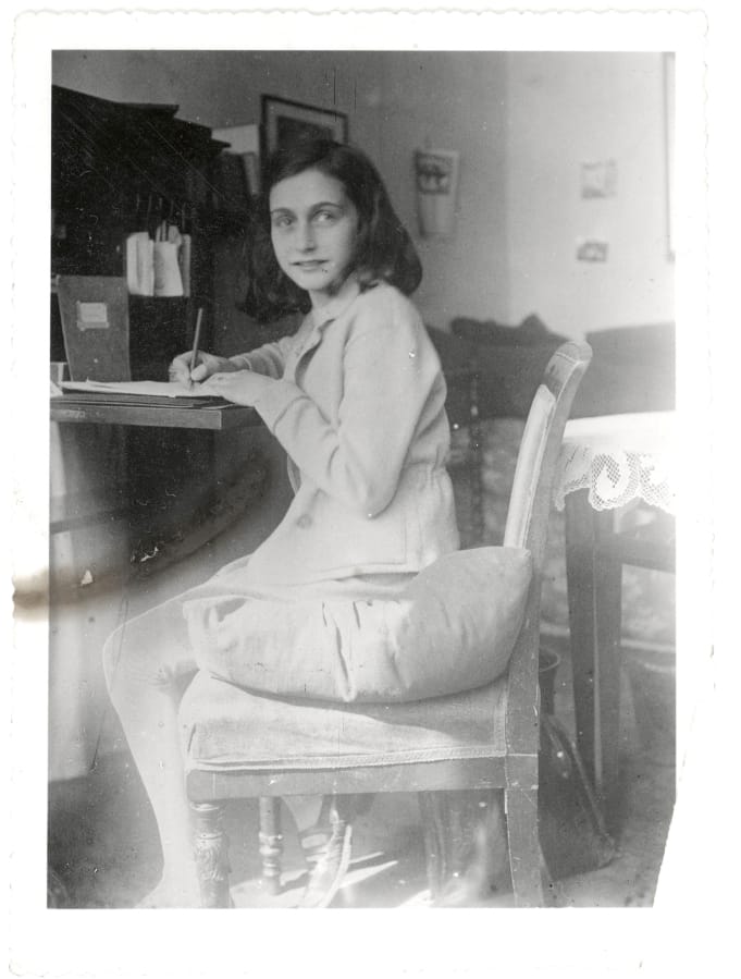 This April 1941 image released by the Anne Frank Foundation shows Anne Frank writing.