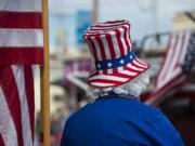 Ed Martin of Ridgefield gets into the spirit of the Fourth of July dressed as Uncle Sam as he enjoys the annual parade from his spot along Pioneer Street on Wednesday morning, July 4, 2018.(Amanda Cowan/The Columbian)