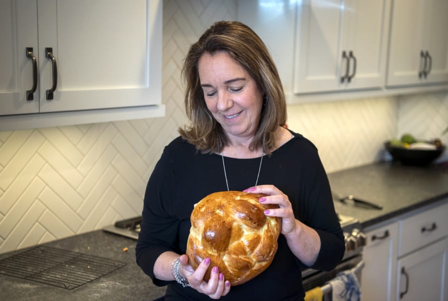 Lisa Spiegel prepares a round challah loaf. The bread is a Jewish tradition that dates back centuries.