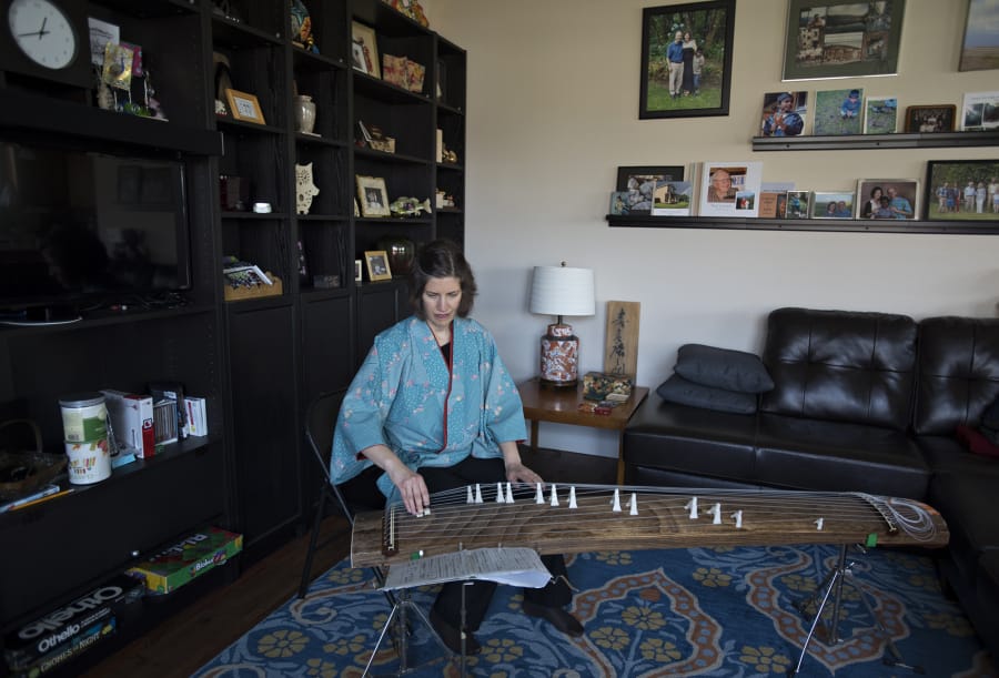 Sarah Coomber, who spent years teaching in Japan, plays the koto, or Japanese zither, at her home near Five Corners. Coomber is the author of a new memoir about her time spent in Japan.
