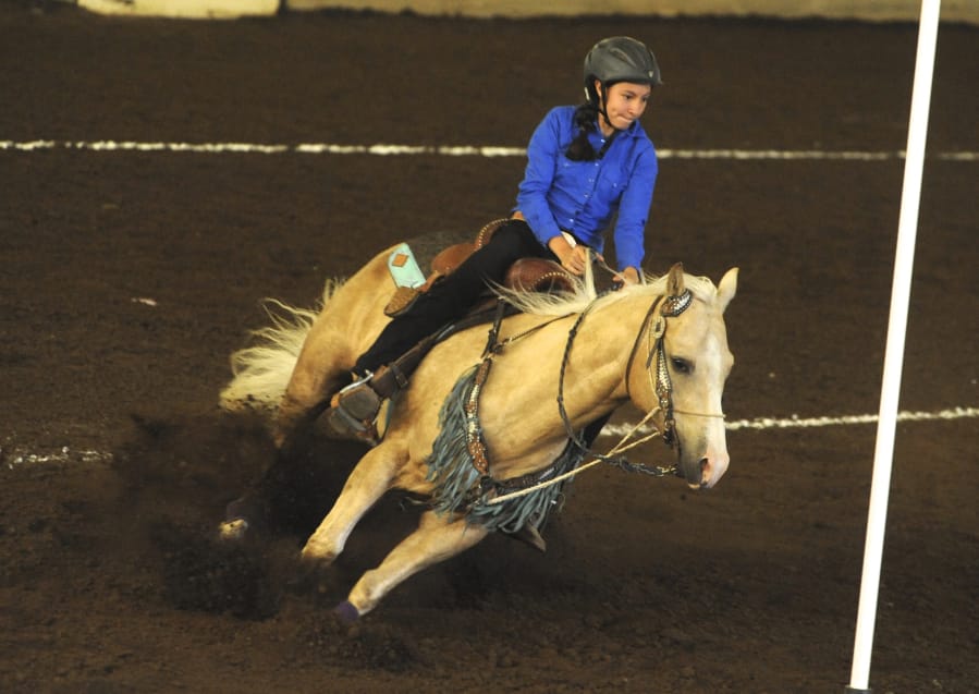 Contestant Hailey Saeman rides Chex to Chex in the figure 8 competition on Sunday during the 4-H Horse Pre-Fair Performance Show at the Clark County Event Center at the Fairgrounds.