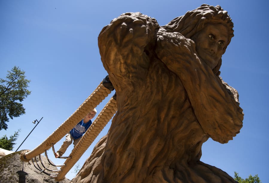 Hayes Hatfield of Camas, 4, climbs on Eegah, the Sasquatch statue in the center of the Port of Camas-Washougal’s new natural play area along the Washougal Waterfront Park walking path. The play structure includes the towering Sasquatch, climbing ropes, logs and musical instruments.
