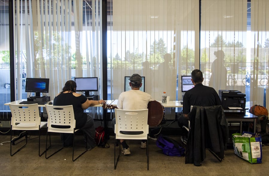 People use the computers at the Vancouver Navigation Center on Tuesday. The center, which opened in November, is designed to be a safe and welcoming space for anyone experiencing homelessness, whether or not they’re ready to seek out long-term housing solutions.