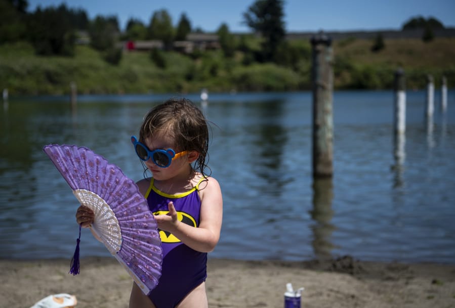 Mara Yedinak, 3, of Portland plays with her fan as her mom gets ready to pack up Tuesday afternoon at Klineline Pond in Vancouver.