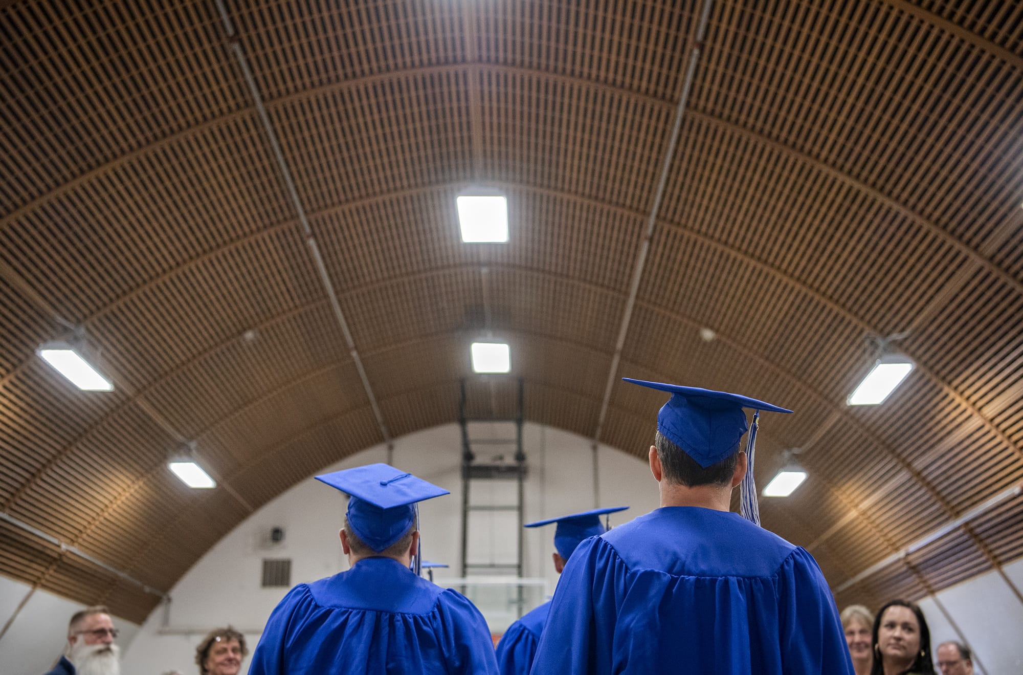 Graduates walk through the gymnasium during the commencement ceremony for Clark College graduates at Larch Corrections Center in Yacolt on Wednesday, June 19, 2019. About 100 men walked in the graduation ceremony with recently completed General Educational Development certificates, and college programs in automotive and maintenance service, business and supervisory management. More than 20 men also revived honors on the Clark College honor roll.