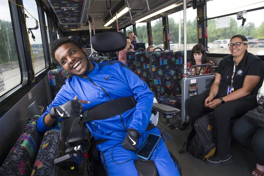 Nate Habtom laughs while riding a C-Tran bus bound for Portland with C-Tran Travel Trainer Jade Dudley, far right, during a training session last week. The two have become friends over the last year that Habtom has trained with Dudley, who focuses much of her work on helping seniors and those with disabilities. “It’s helping them gain or maintain independence. There’s really no greater gift than seeing that spark for them,” Dudley said.