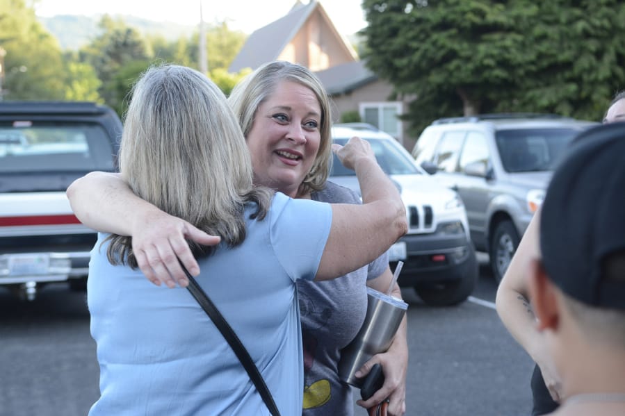 Shauna Walters of Battle Ground hugs a supporter outside Yacolt Town Hall after the town council voted to declare itself a sanctuary from Initiative 1639, a gun measure state voters passed in November.