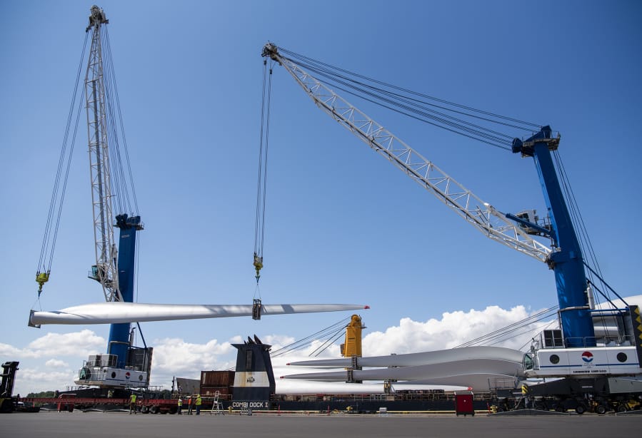 Alisha Jucevic/The Columbian Workers unload 49-meter Vestas wind turbine blades at the Port of Vancouver on Wednesday. The shipment set a record - the largest-ever shipment of wind turbine blades shipped on a single vessel. The 198 blades traveled from Italy and are destined for PacifiCorp´s Marengo Wind Project near Dayton.