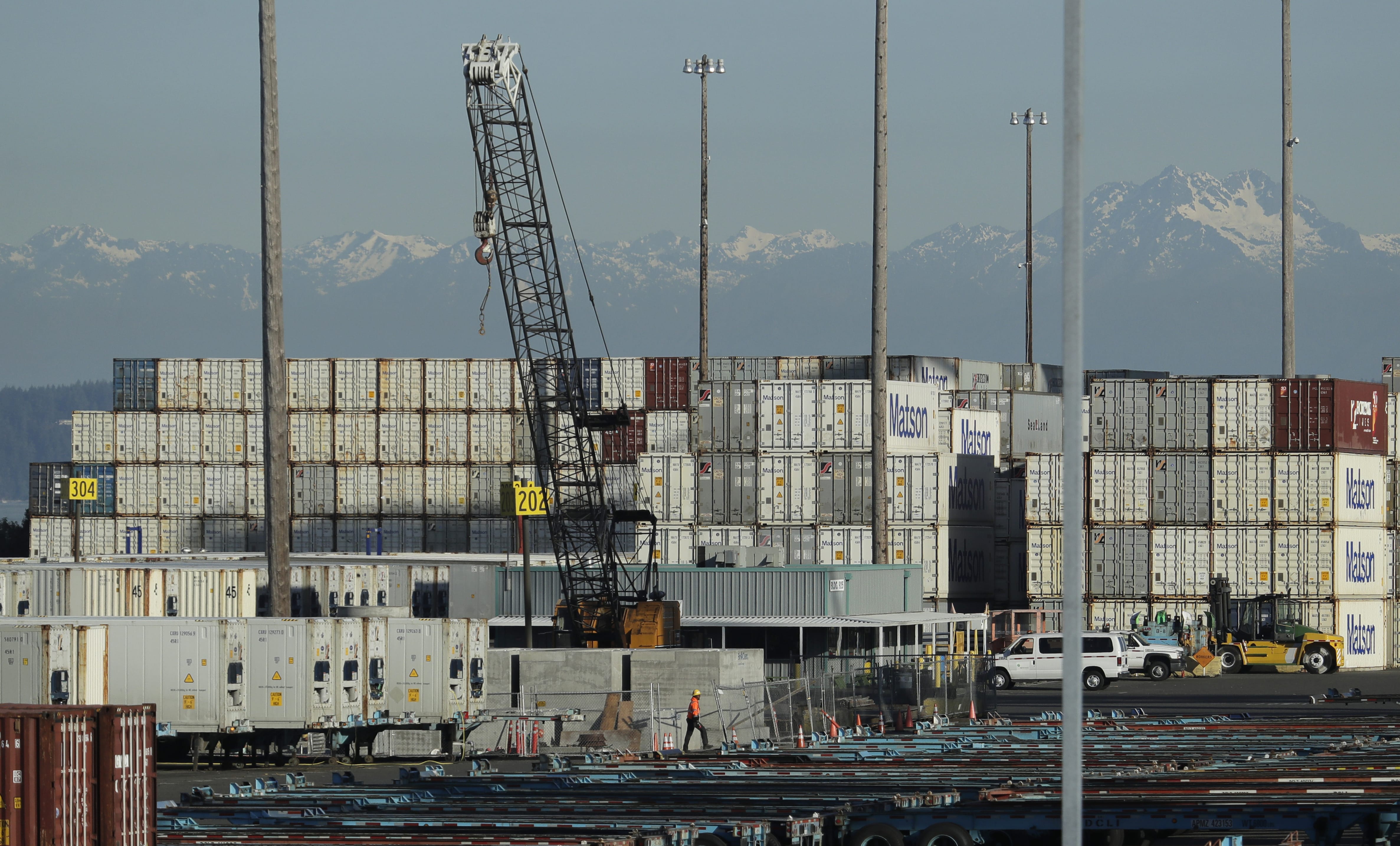 A worker walks near truck trailers and cargo containers at the Port of Tacoma in Tacoma. Hundreds of businesses, trade groups and individuals have written to complain about President Donald Trump's threat to impose tariffs on the remaining $300 billion in Chinese goods that he hasn't already hit with 25% import taxes, saying the additional import taxes would drive up prices for consumers, squeeze profits and leave U.S. companies at a competitive disadvantage to foreign rivals that aren't subject to higher taxes on the vital components they buy from China.  (AP Photo/Ted S.