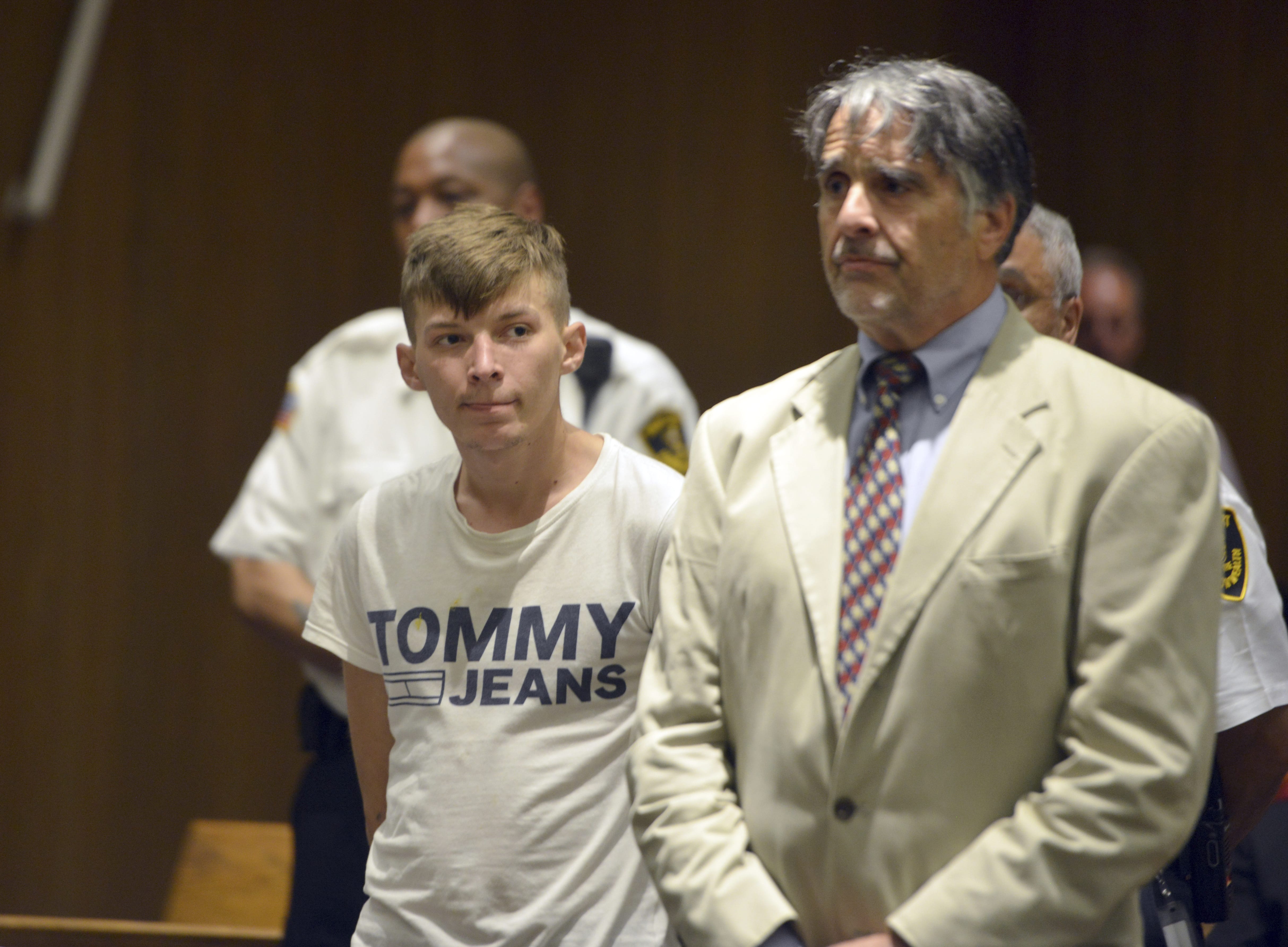 Volodymyr Zhukovskyy, 23, of West Springfield, stands with his attorney Donald Frank during his arraignment in Springfield District Court, Monday, June 24, 2019, in Springfield, Mass. Zhukovskyy, the driver of a truck in a fiery collision on a rural New Hampshire highway that killed seven motorcyclists, was charged Monday with seven counts of negligent homicide.