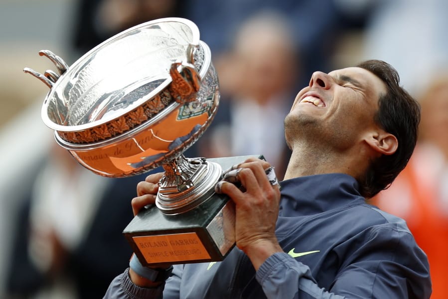 Spain’s Rafael Nadal lifts the cup after defeating Austria’s Dominic Thiem in their men’s final match of the French Open tennis tournament at the Roland Garros stadium in Paris, Sunday, June 9, 2019. Nadal won 6-3, 5-7, 6-1, 6-1.