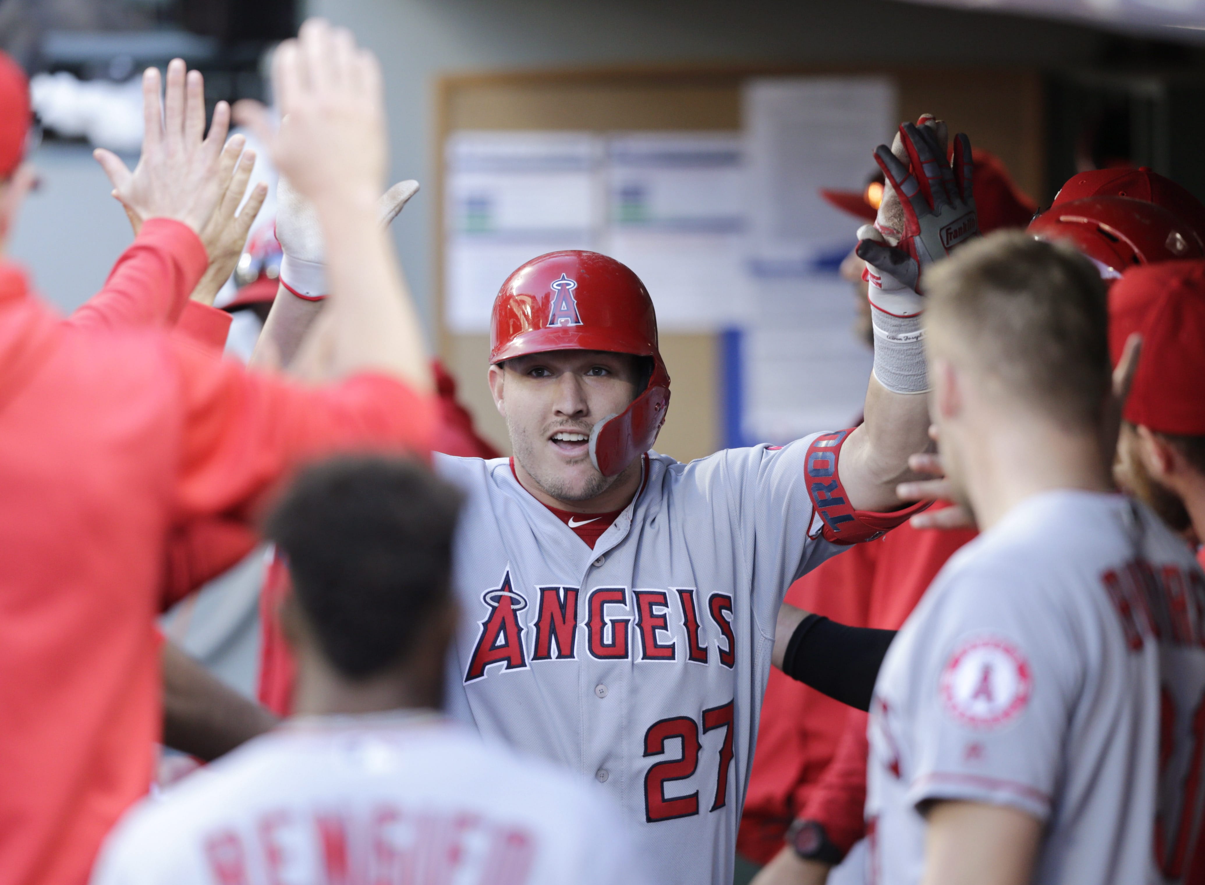 Los Angeles Angels' Mike Trout celebrates in the dugout after hitting a home run against the Seattle Mariners during the ninth inning of a baseball game Saturday, June 1, 2019, in Seattle.
