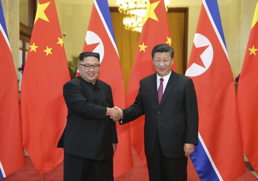 FILE - In this June 19, 2018, file photo released by China’s Xinhua News Agency, Chinese President Xi Jinping, right, poses with North Korean leader Kim Jong Un for a photo during a welcome ceremony at the Great Hall of the People in Beijing. Chinese state media say President Xi Jinping will make a state visit to North Korea this week. State broadcaster CCTV said in its evening news program on Monday that Xi will meet with North Korean leader Kim Jong Un during a visit Thursday and Friday.