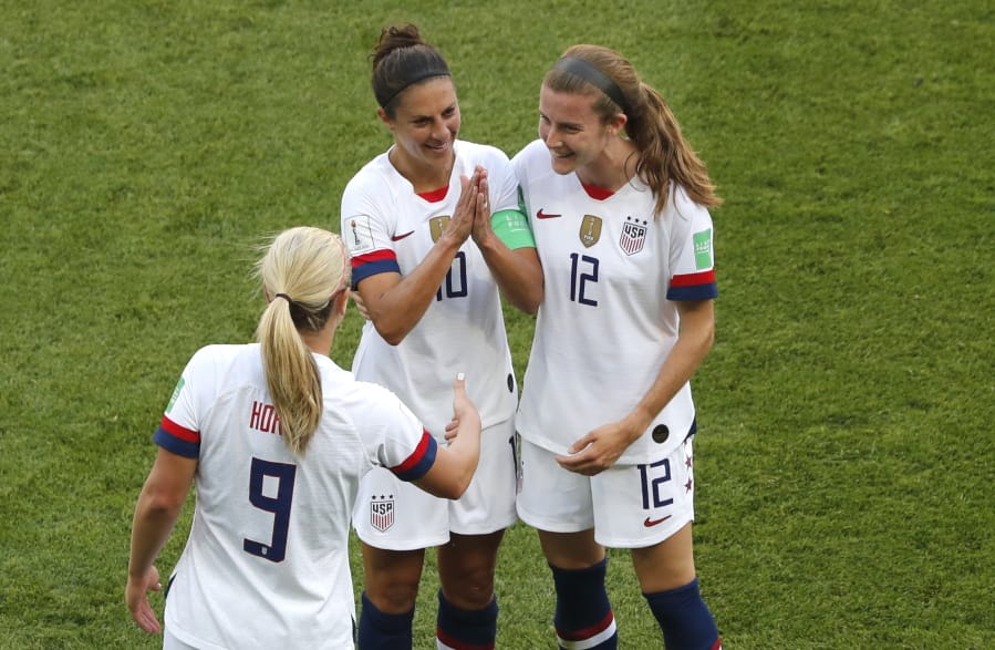 United States’ Carli Lloyd , center, celebrates with Lindsey Horan and Tierna Davidson, right, after scoring the opening goal during the Women’s World Cup Group F soccer match between the United States and Chile at the Parc des Princes in Paris, Sunday, June 16, 2019.