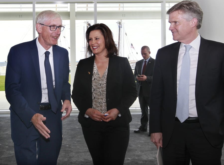 Wisconsin Gov. Tony Evers, left, Michigan Gov. Gretchen Whitmer and Ontario’s Minister of the Environment, Conservation and Parks, Rod Phillips, leave a press conference after sharing highlights of their 2019 Leadership Summit at the Discovery World, Friday, June 14, 2019 in Milwaukee, Wis.