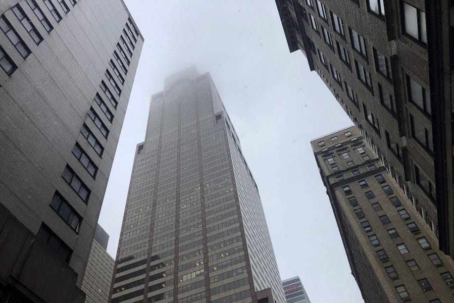 Mist and smoke cover the top of a building near 51st Street and 7th Avenue Monday, June 10, 2019, in New York, where a helicopter was reported to have crash landed on top of the roof of a building in midtown Manhattan.
