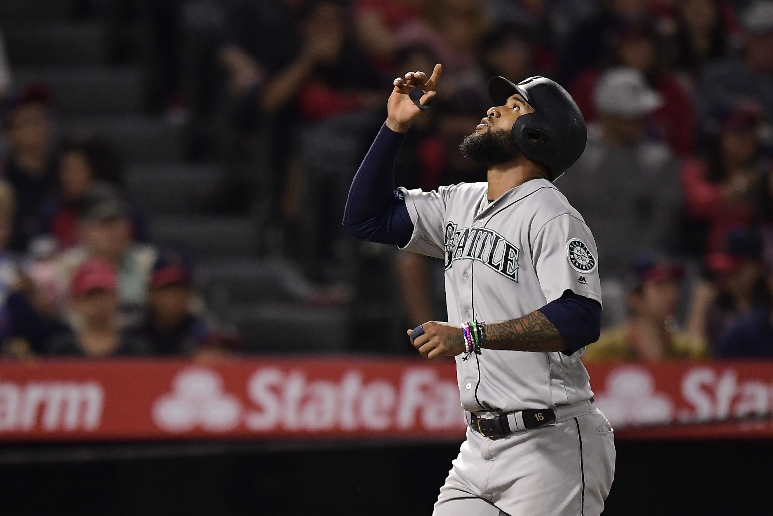 Seattle Mariners' Domingo Santana gestures as he scores after hitting a solo home run during the fifth inning of the team's baseball game against the Los Angeles Angels on Friday, June 7, 2019, in Anaheim, Calif. (AP Photo/Mark J.