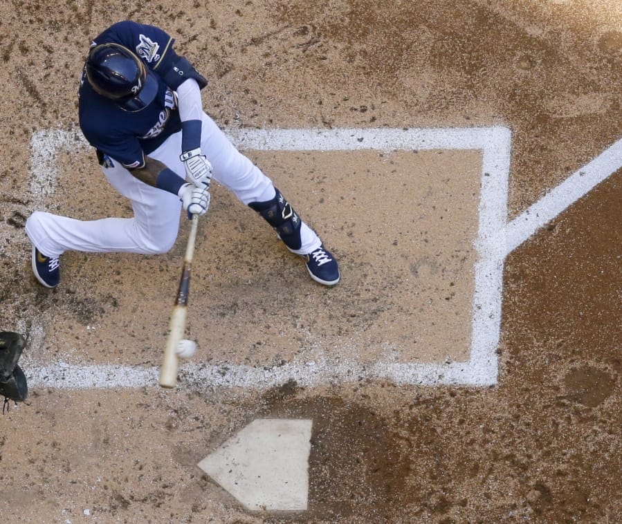 Milwaukee Brewers’ Orlando Arcia hits a three-run home run during the fourth inning of a baseball game against the Seattle Mariners Thursday, June 27, 2019, in Milwaukee.