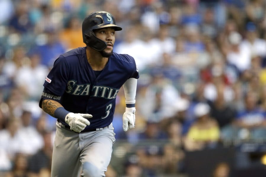 Seattle Mariners’ J.P. Crawford watches his RBI triple during the second inning of the team’s baseball game against the Milwaukee Brewers on Wednesday, June 26, 2019, in Milwaukee.