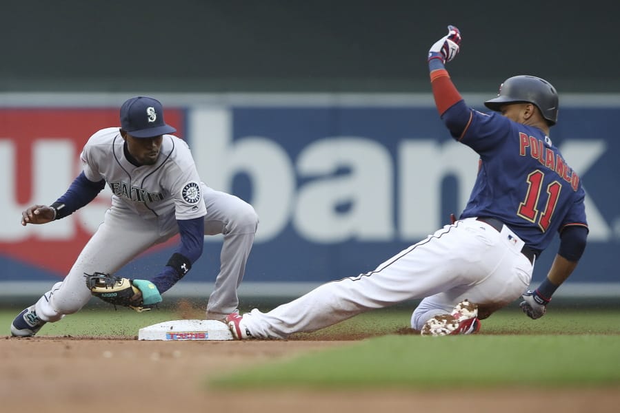 Minnesota Twins’ Jorge Polanco slides safely into second base against Seattle Mariners’ Dee Gordon with a double during the first inning of a baseball game Tuesday, June 11, 2019, in Minneapolis.