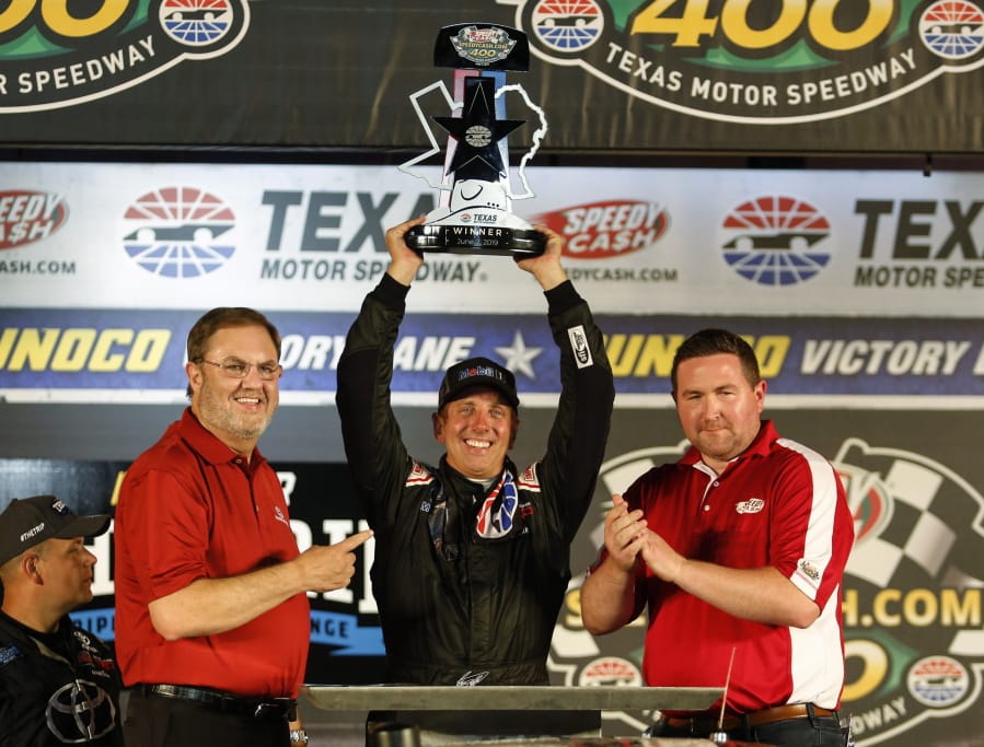 Greg Biffle raises the trophy after winning the NASCAR Truck Series auto race at Texas Motor Speedway in Fort Worth, Texas, Friday, June 7, 2019.
