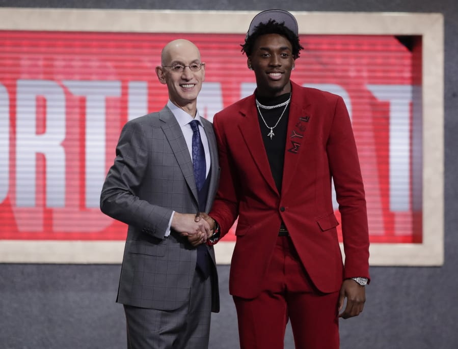 NBA Commissioner Adam Silver, left, poses for photographs with North Carolina's Nassir Little after the Portland Trail Blazers selected him with the 25th pick overall in the NBA basketball draft Thursday, June 20, 2019, in New York.