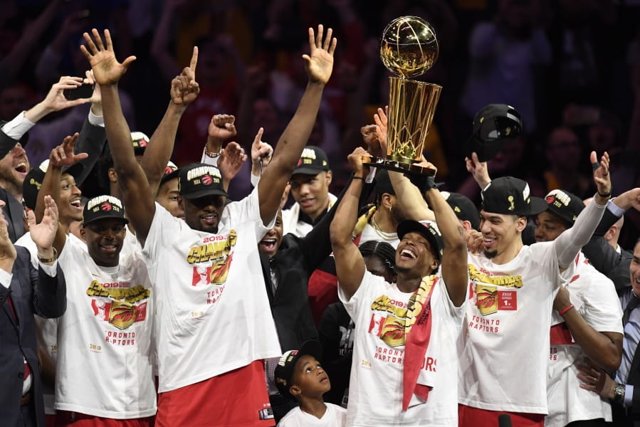 Toronto Raptors guard Kyle Lowry, center right, holds Larry O’Brien NBA Championship Trophy after the Raptors defeated the Golden State Warriors 114-110 in Game 6 of basketball’s NBA Finals, Thursday, June 13, 2019, in Oakland, Calif.