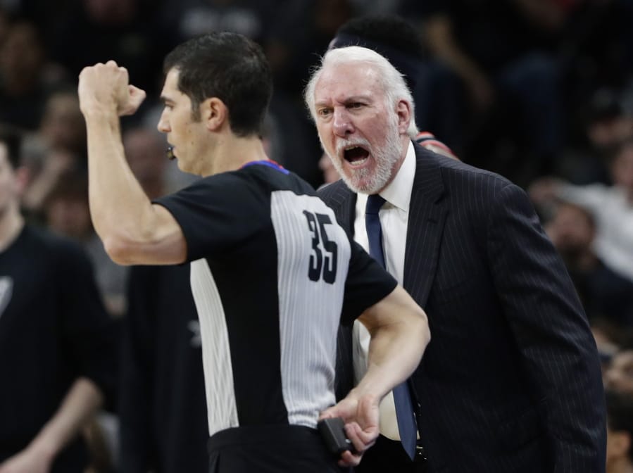San Antonio Spurs head coach Gregg Popovich, right, argues a call with referee Steve Anderson (35).