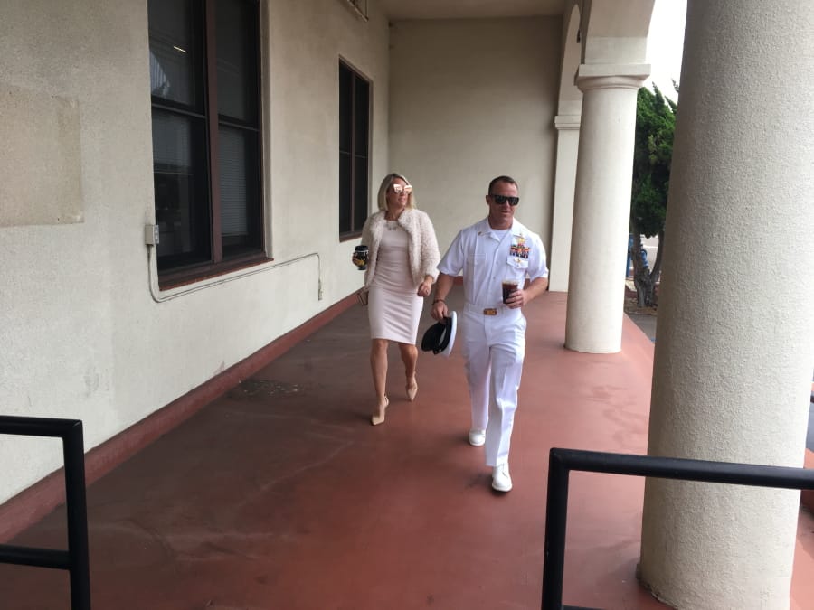 Navy Special Operations Chief Edward Gallagher, right, walks with his wife, Andrea Gallagher as they arrive to military court on Naval Base San Diego, Monday, June 24, 2019, in San Diego. Trial continues in the court-martial of the decorated Navy SEAL, who is accused of stabbing to death a wounded teenage Islamic State prisoner and wounding two civilians in Iraq in 2017. He has pleaded not guilty to murder and attempted murder, charges that carry a potential life sentence.