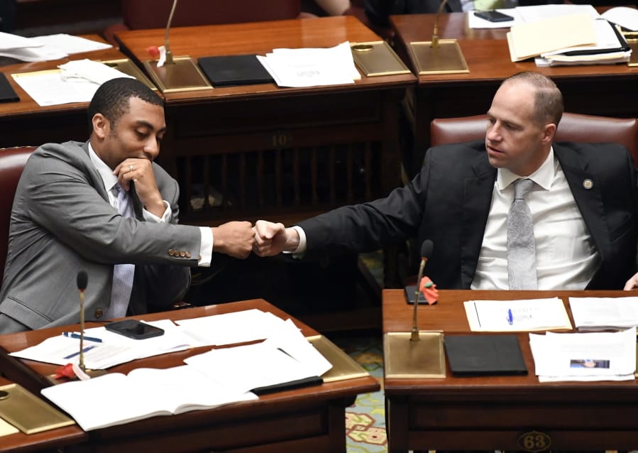 New York Sen. Jamaal T. Bailey, D-Bronx, left, fist bumps Sen. Timothy M. Kennedy, D-Buffalo, after Bailey’s legislation expanding decriminalization legislation for marijuana passed during a legislative session the Senate Chamber at the state Capitol Thursday, June 20, 2019, in Albany, N.Y.