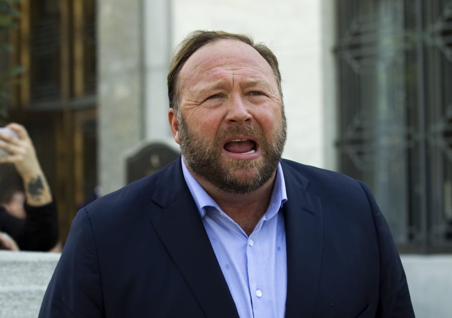 FILE--In this Sept. 5, 2018 file photo, Alex Jones speaks to reporters in Washington. Lawyers in Connecticut, on Monday, June 17, 2019, allege conspiracy theorist Alex Jones sent them electronic files containing child pornography as part of a defamation lawsuit against the Infowars host by relatives of some victims of the Sandy Hook Elementary School shooting. The families of eight victims of the 2012 shooting in Newtown, Conn. and an FBI agent who responded to the massacre are suing Jones, Infowars and others for promoting a theory that the shooting was a hoax.
