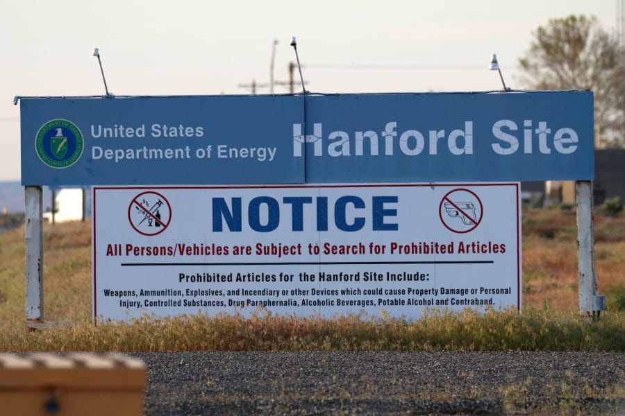 FILE - In this May 9, 2017 file photo, signs are posted near the entrance to the Hanford Nuclear Reservation in Richland, Wash. A federal judge on Thursday, June 13, 2019 rejected the Trump administration’s challenge to a Washington state law that makes it easier for former workers at the Hanford Nuclear Reservation to win workers compensation benefits.