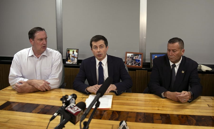 South Bend Mayor Pete Buttigieg, center, speaks during a news conference, Sunday, June 16, 2019, in South Bend, Ind., as South Bend Common Council President Tim Scott, left, and South Bend Police Chief Scott Ruszkowski, listen. Democratic presidential candidate Buttigieg changed his campaign schedule to return to South Bend for the late night news conference, after authorities say a man died after a shooting involving a police officer.