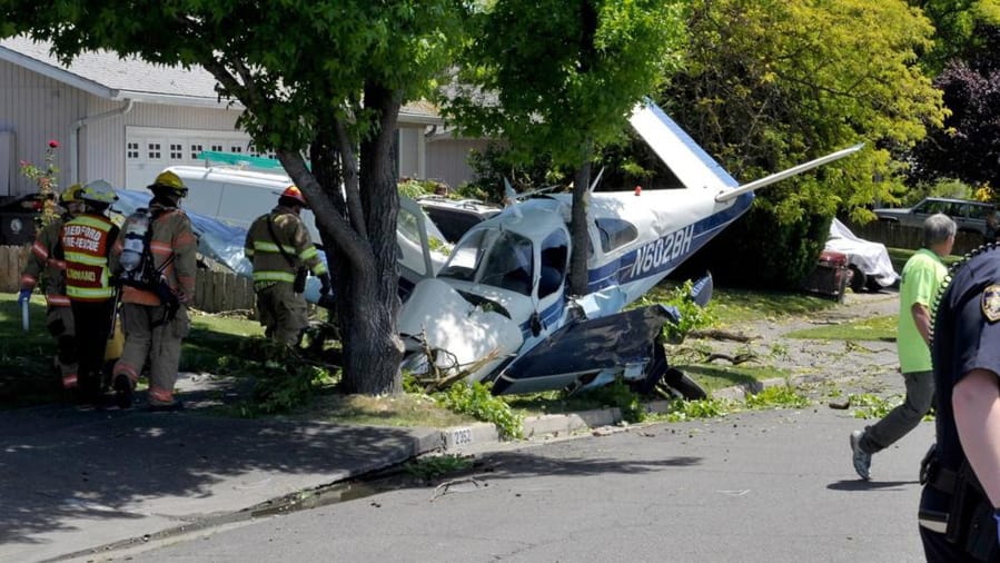 First responders work the scene of a plane crash, Saturday in Medford, Ore. Authorities say the pilot and a passenger were injured after a small plane has crashed in Medford.