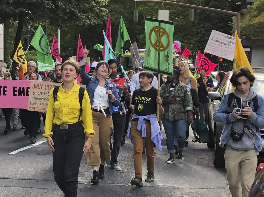 In this photo taken June 21, 2019, people demonstrating to raise awareness of climate change blocked streets in downtown Portland, Ore. The divide in Oregon between the state’s liberal, urban population centers and its conservative and economically depressed rural areas makes it fertile ground for the political crisis unfolding over a push by Democrats to enact sweeping climate legislation. Just three years after armed militia members took over a national wildlife refuge in southeastern Oregon, some of the same groups are now seizing on a walkout by Oregon’s GOP senators to broadcast their anti-establishment message.