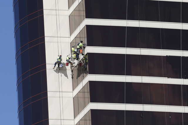 In this May 22, 2019, file photo window washers work on Encore Boston Harbor in Everett, Mass. On Thursday, June 6, the Labor Department issues revised data on productivity in the first quarter.
