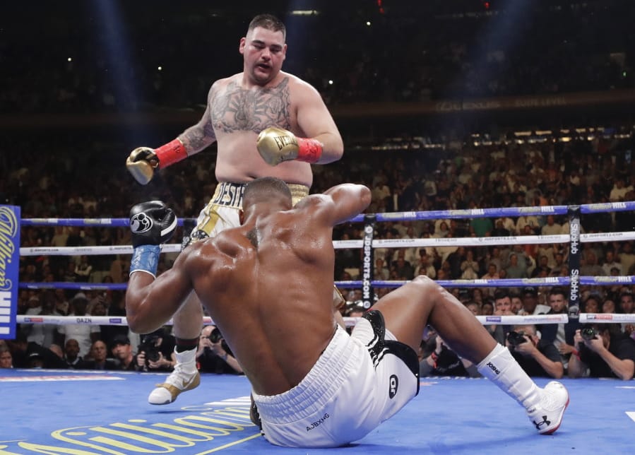 Andy Ruiz knocks down Anthony Joshua during the third round of a heavyweight title boxing match Saturday, June 1, 2019, in New York. Ruiz won in the seventh round.