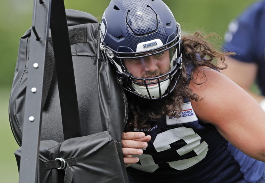 Seattle Seahawks center Joey Hunt hits a blocking sled as he runs a drill, Thursday, June 6, 2019, at the team’s NFL football training facility in Renton, Wash. (AP Photo/Ted S.