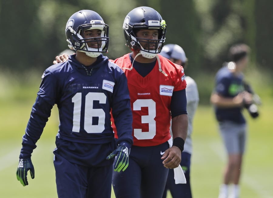 Seattle Seahawks quarterback Russell Wilson (3) walks off the field with wide receiver Tyler Lockett (16) following an organized team activity Tuesday, June 4, 2019, at the team’s NFL football training facility in Renton, Wash. (AP Photo/Ted S.