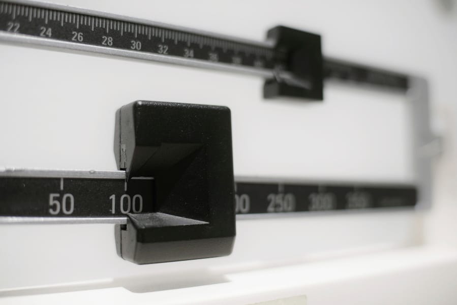 FILE - This April 3, 2018, file photo shows a closeup of a beam scale in New York. A study released on Tuesday, June 18, 2019, found U.S. preschoolers on government food aid have grown a little less pudgy, offering fresh evidence that previous signs of shrinking obesity weren’t a fluke. Obesity rates dropped to about 14 percent in 2016, the latest data available and a steady decline from 16 percent in 2010, researchers from the federal Centers for Disease Control and Prevention reported.