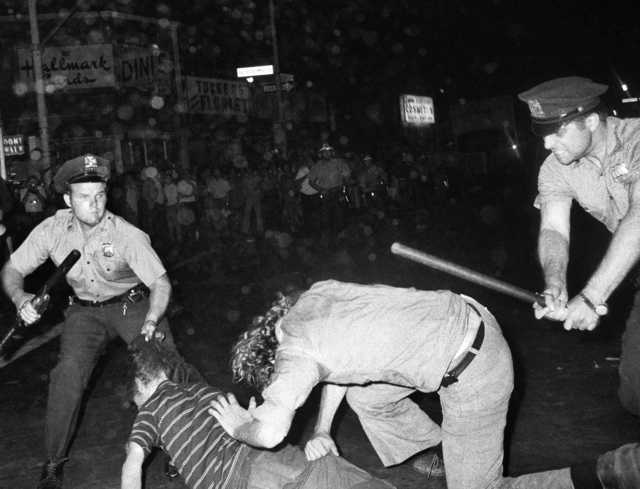 In this Aug. 31, 1970 file photo, an NYPD officer grabs a youth by the hair as another officer clubs a young man during a confrontation in Greenwich Village after a Gay Power march in New York. A year earlier, the June 1969 uprising by young gays, lesbians and transgender people in New York City, clashing with police near a bar called the Stonewall Inn, was a vital catalyst in expanding LGBT activism nationwide and abroad.